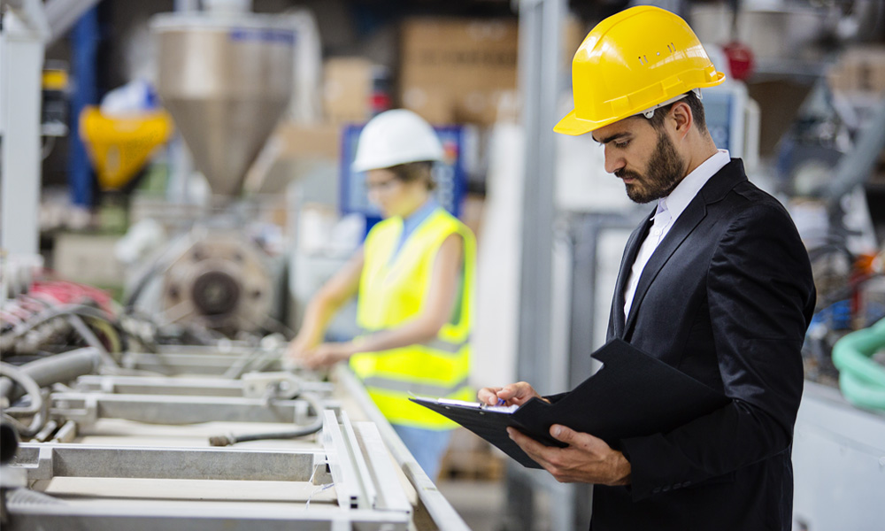 worker with checklist in factory