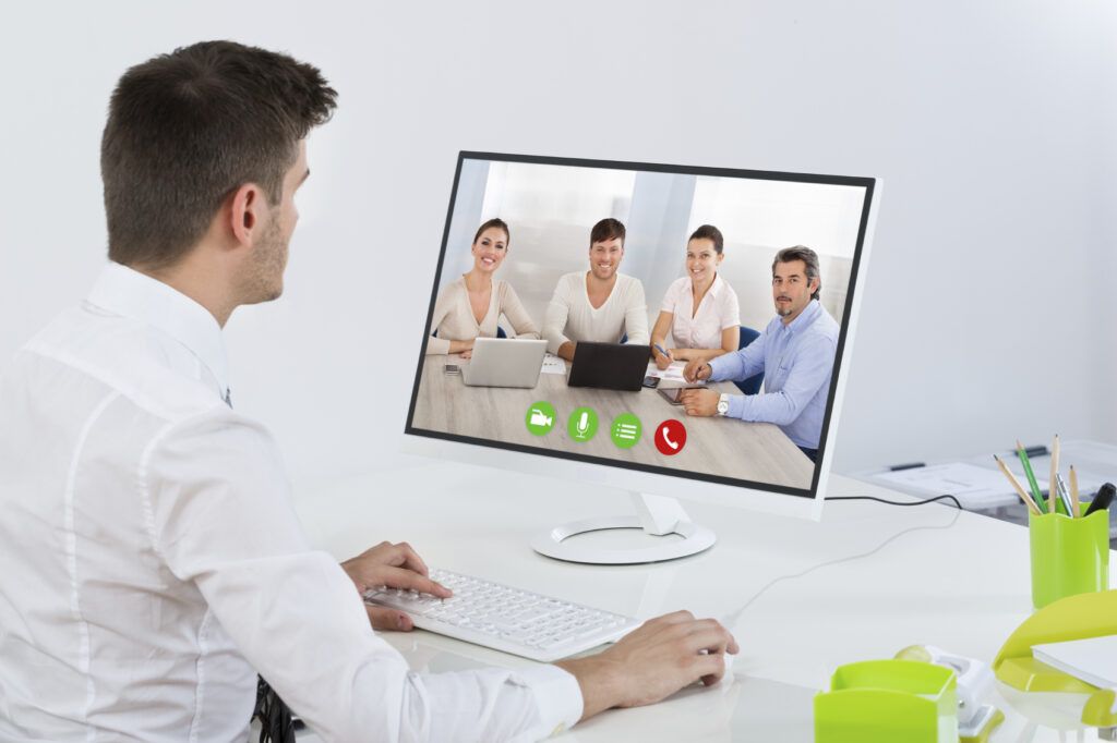 Young Businessman Videoconferencing With Colleagues On Computer