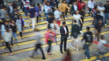 man recieving notification in busy street