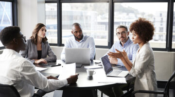 Millennial Black Businesswoman Addressing Colleagues At A Corporate Business Meeting, Close Up