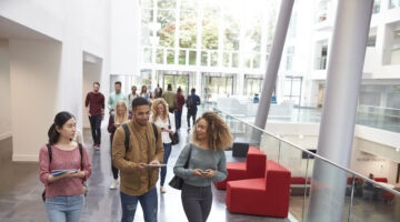 Students Walk And Talk Using Mobile Devices In University