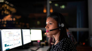 Support tech looking thoughtfully at a monitor