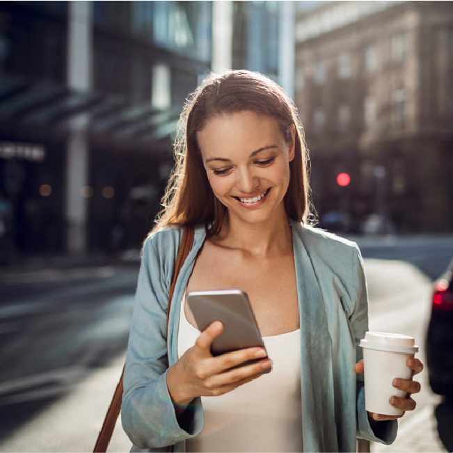 woman happily looking at phone