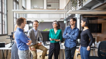 Happy Business Team Having A Standing Meeting In Office