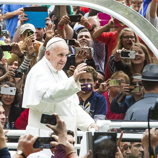 Pope Francis waving to crowd of spectators