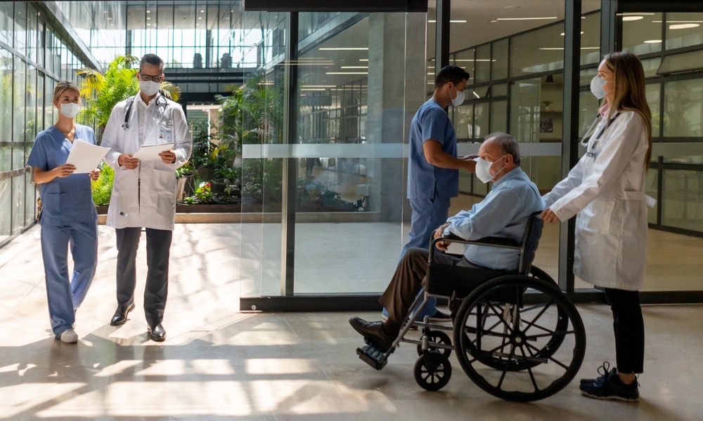People Walking In And Out Of The Hospital