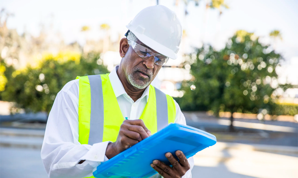 Workplace safety manager reviewing checklist on clipboard