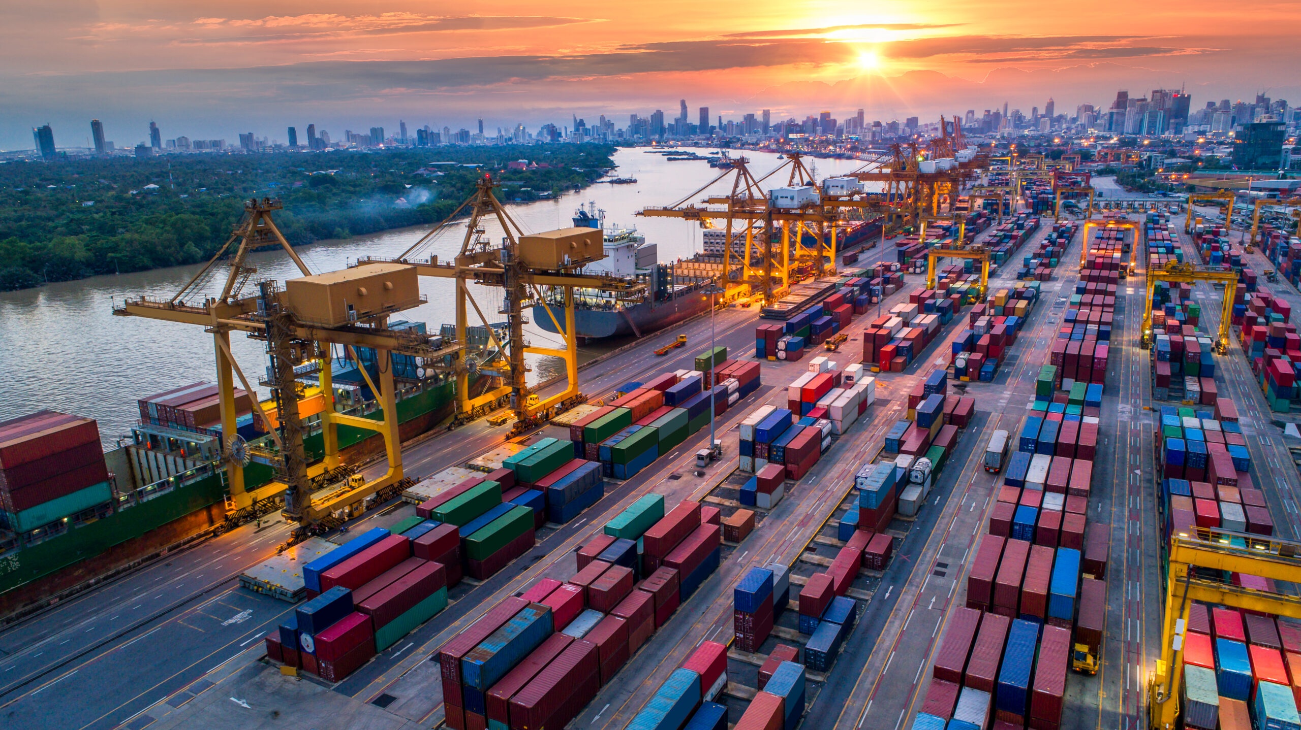 Logistics And Transportation Of Container Cargo Ship And Cargo Plane With Working Crane Bridge In Shipyard At Sunrise,